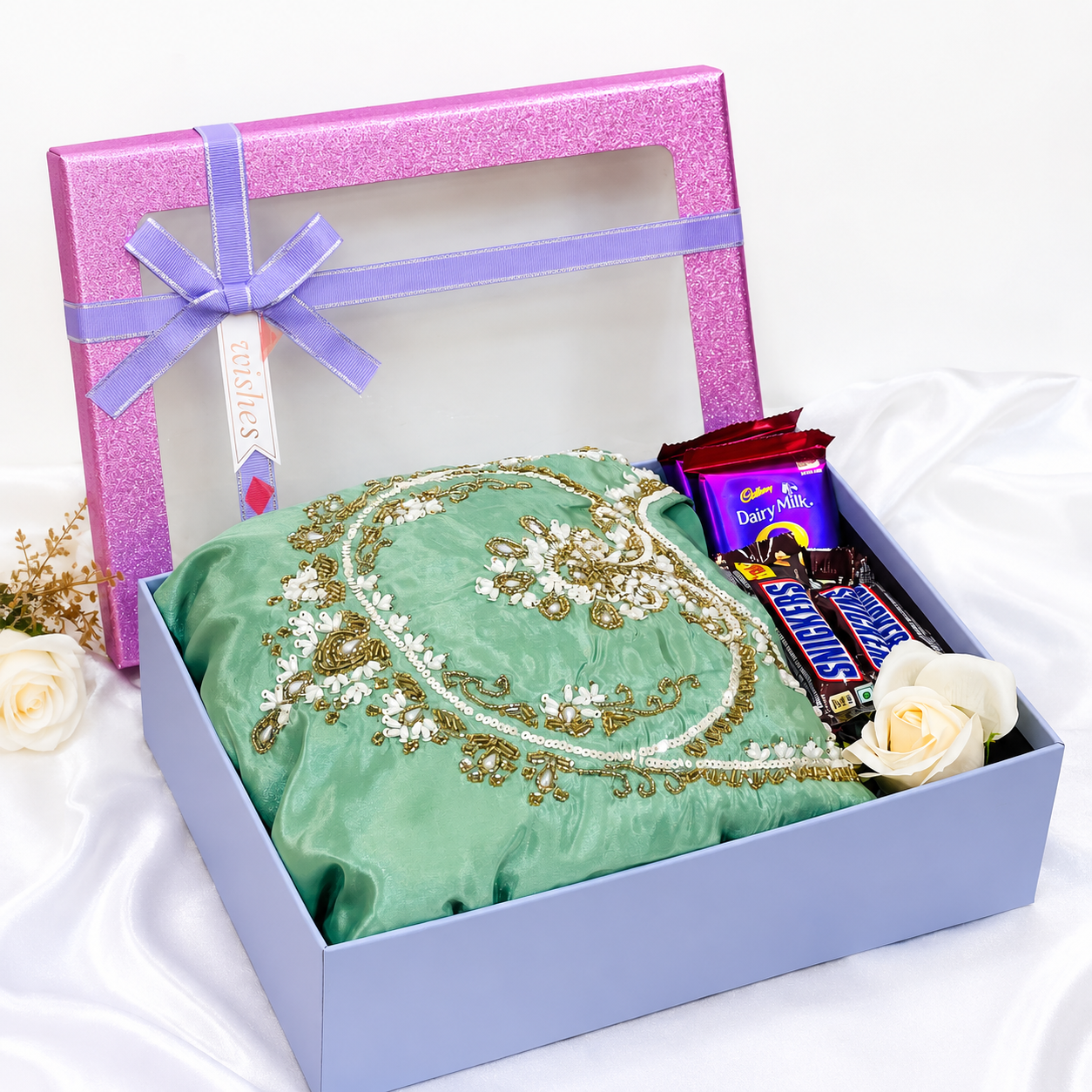 Premium party wear gift hamper with mint green embellished dress, Dairy Milk chocolates, Snickers bars and decorative flower in luxury gift box