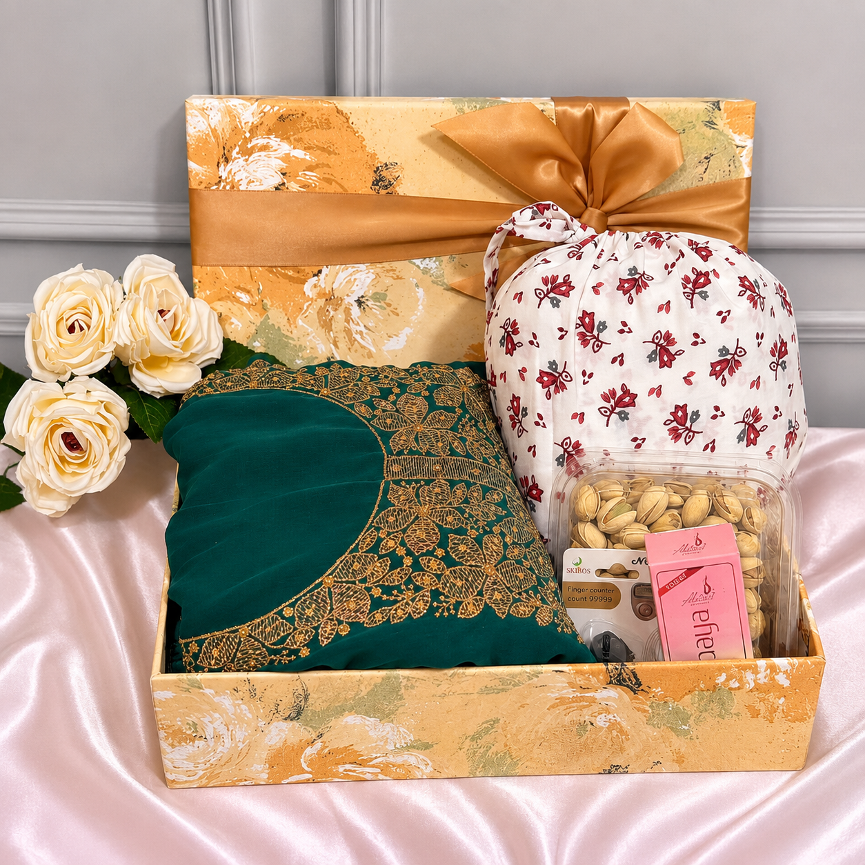 Luxury Islamic gift hamper with a prayer dress, digital dhikr counter, premium attar perfume, pistachios, and an elegant gift box.