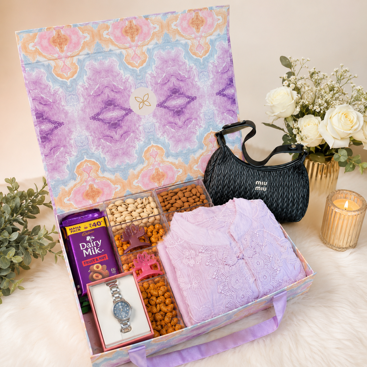 Luxury lavender women's gift hamper featuring an elegant abaya, black handbag, wristwatch, chocolates, pistachios, almonds, masala cashews, hair claw clips, and bun accessories arranged in a premium decorative gift box.