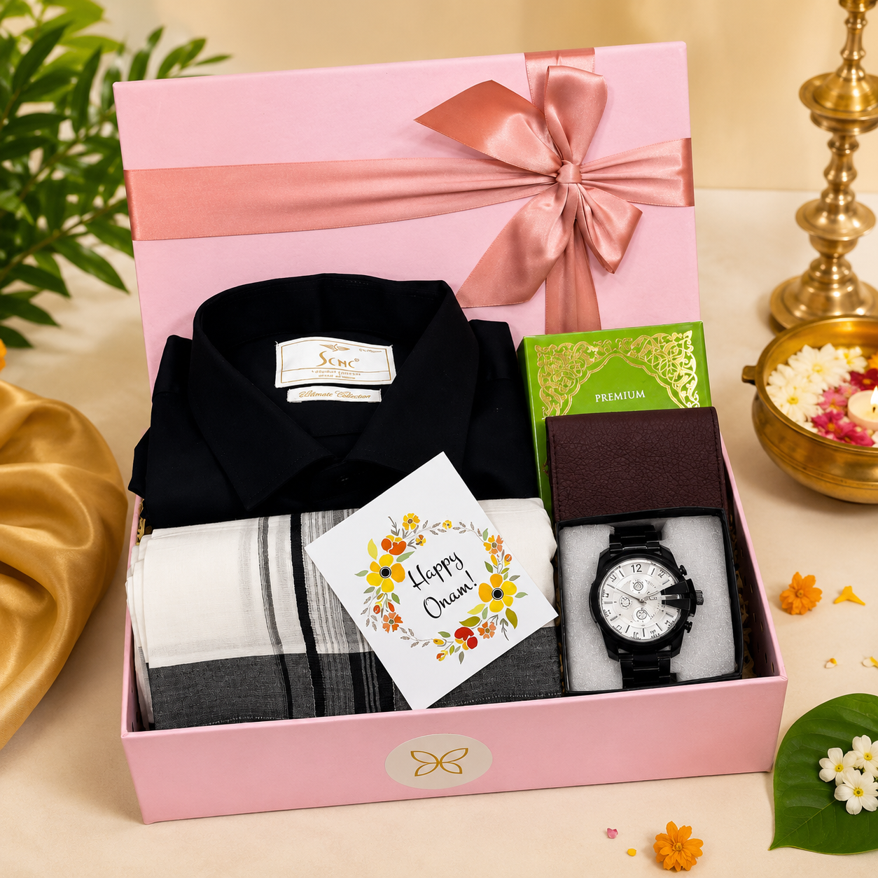 Premium Onam gift hamper for men featuring a black shirt, traditional Kerala mundu, wristwatch, wallet, perfume, and Onam greeting card, beautifully arranged in a luxury pink gift box.