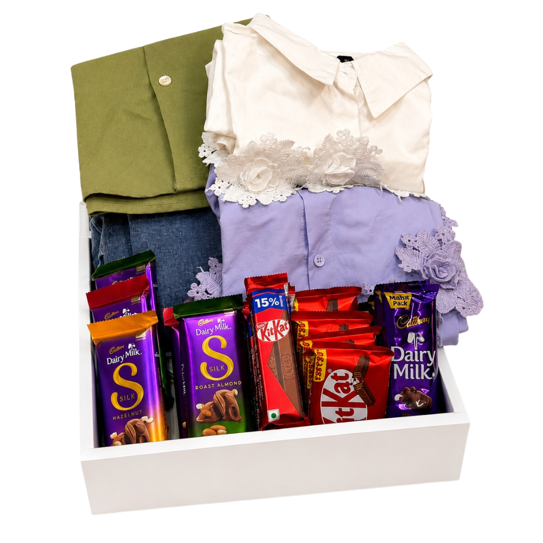 Premium family gift hamper featuring men's olive green shirt, denim jeans, women's floral outfits, Cadbury Dairy Milk Silk chocolates, KitKat, 5 Star chocolates, and Dairy Milk bars beautifully arranged inside a luxury white gift box.