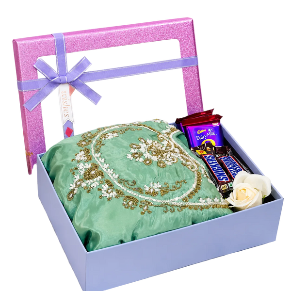 Premium party wear gift hamper with mint green embellished dress, Dairy Milk chocolates, Snickers bars and decorative flower in luxury gift box