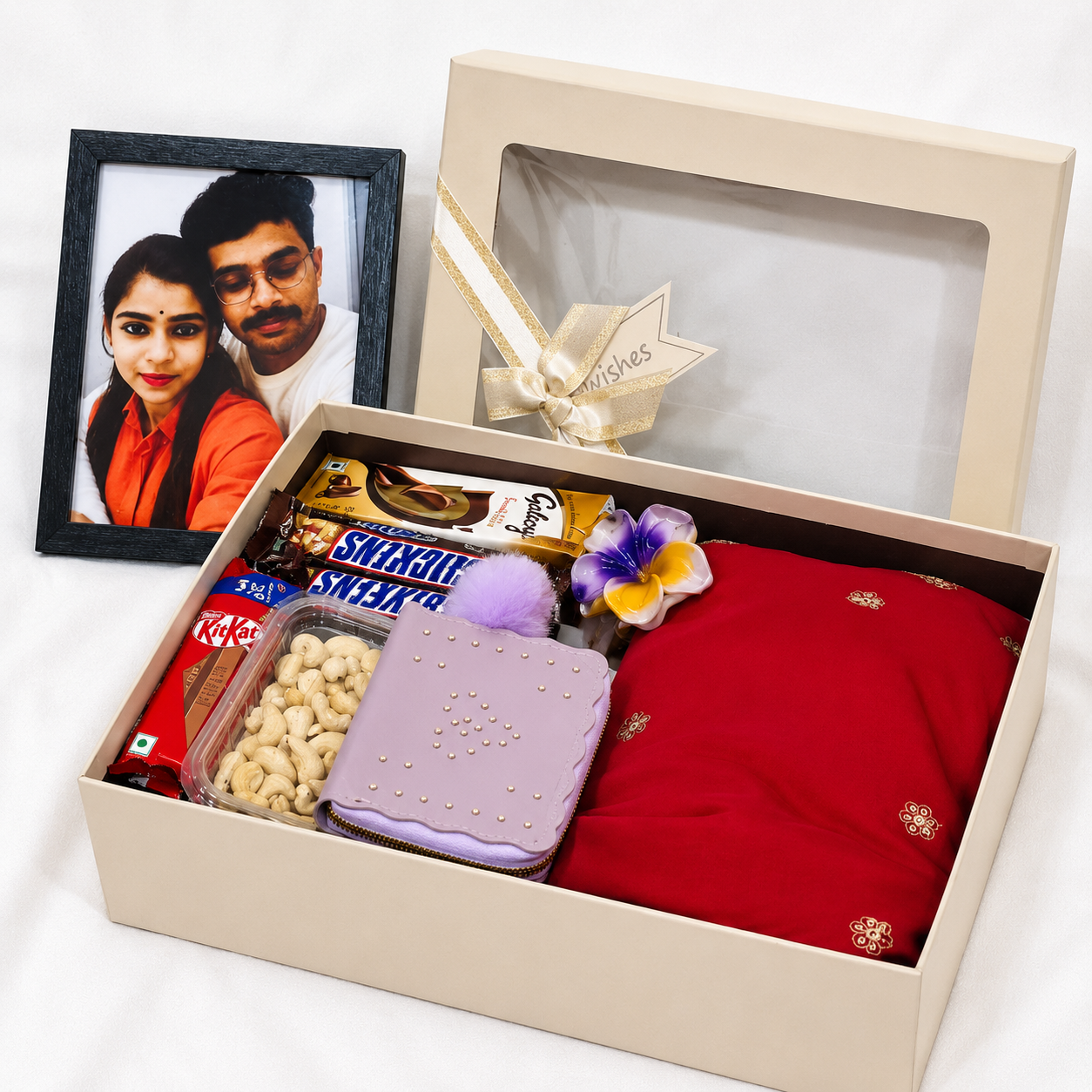 Premium party wear gift hamper with red dress, chocolates, wallet, perfume, cashew nuts and personalized photo frame in luxury gift box